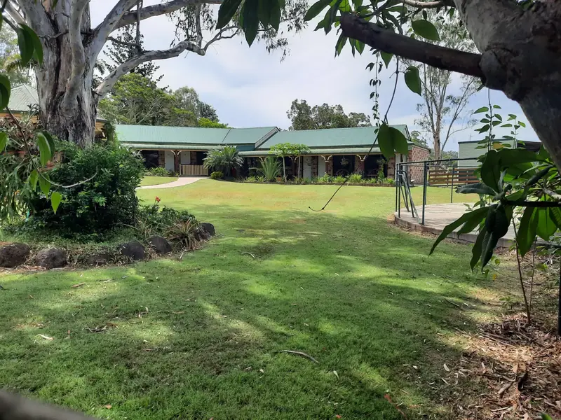 Large acreage lawn under established gum trees after mowing