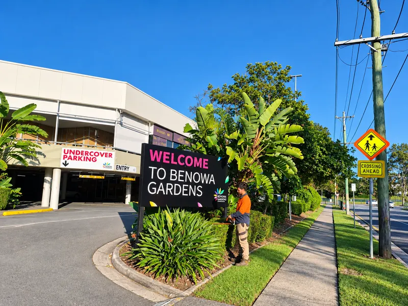 A&V Garden Solutions team member maintaining the gardens at the Benowa Gardens shopping centre entrance