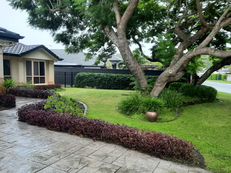Maintained garden beds, hedges and lawn at a residential entry